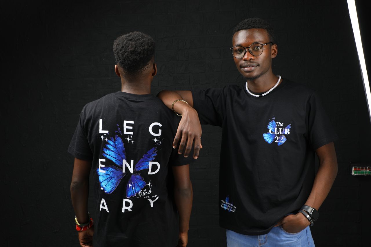 about-us Two young male models showcasing stylish graphic t-shirts with a butterfly design.